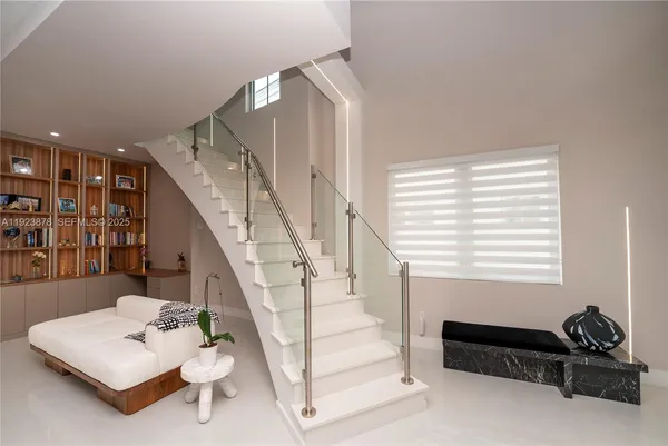 a living room with furniture and stairs