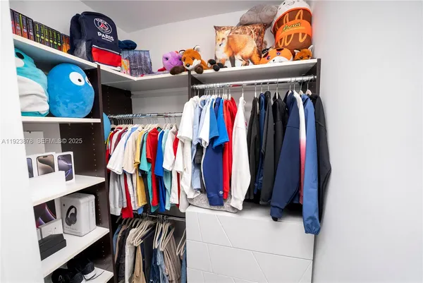 a bathroom with a sink a toilet a mirror and shower