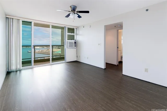a view of room with wooden floor and fan