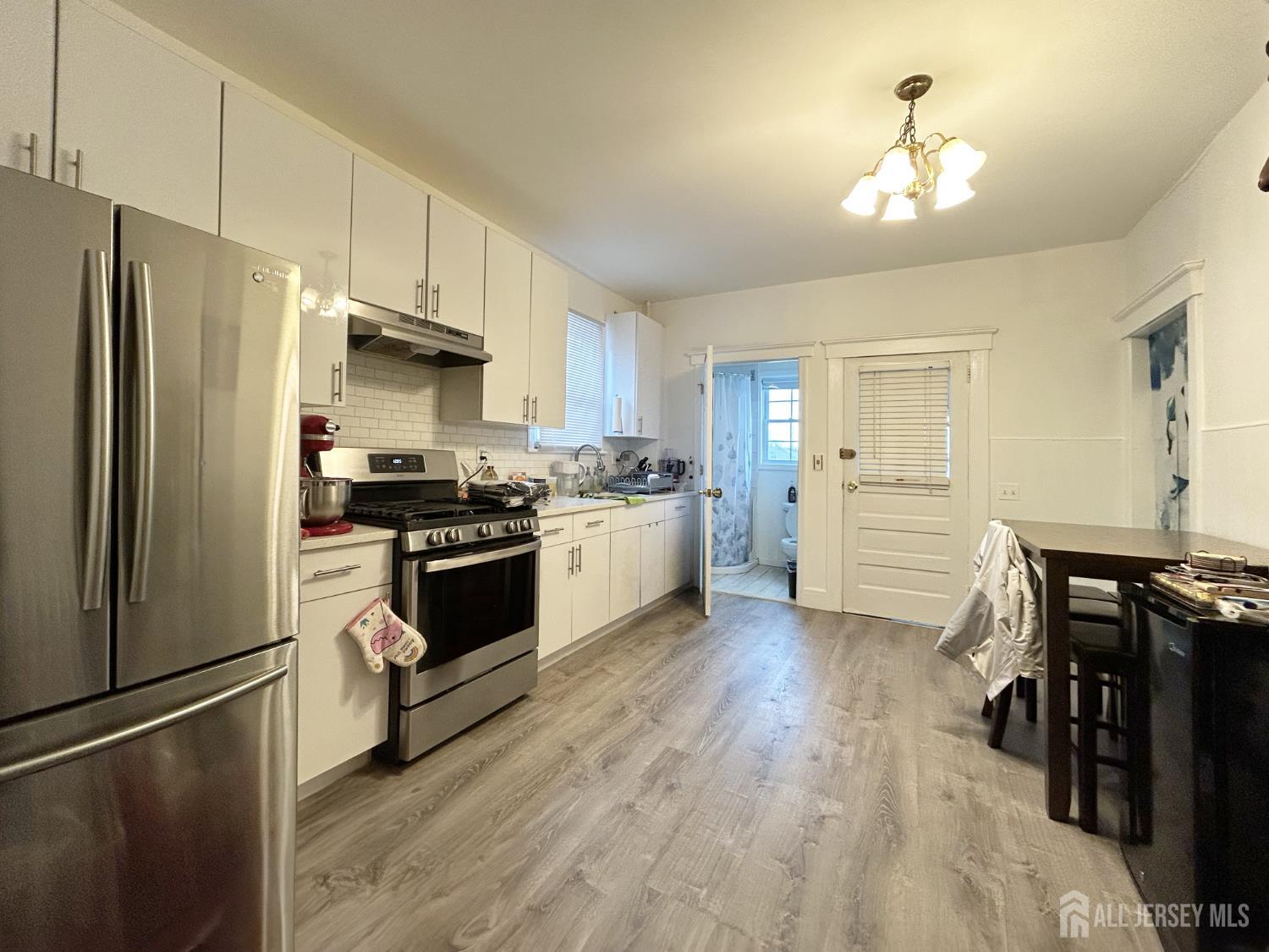 104 Thompson Street Raritan, NJ 08869 - Photo 3 of 10 a kitchen with stainless steel appliances a refrigerator sink and cabinets
