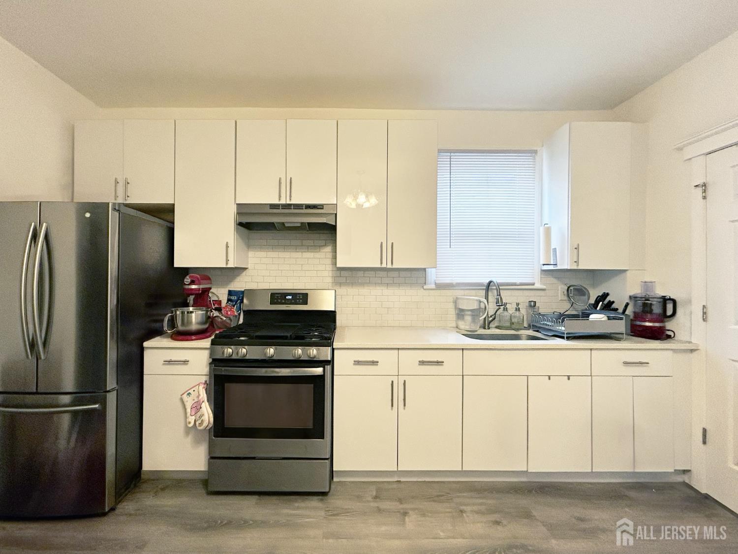 104 Thompson Street Raritan, NJ 08869 - Photo 4 of 10 a kitchen with a refrigerator stove and white cabinets