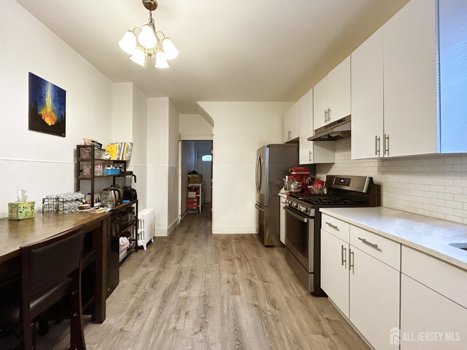 104 Thompson Street Raritan, NJ 08869 - Photo 5 of 10 a kitchen with stainless steel appliances granite countertop a stove top oven a sink dishwasher and a refrigerator