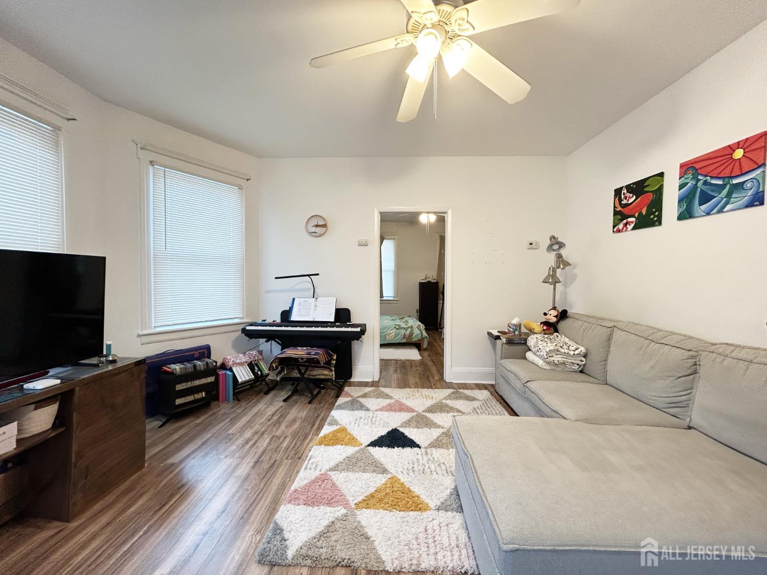 104 Thompson Street Raritan, NJ 08869 - Photo 6 of 10 a bedroom with furniture and a flat screen tv