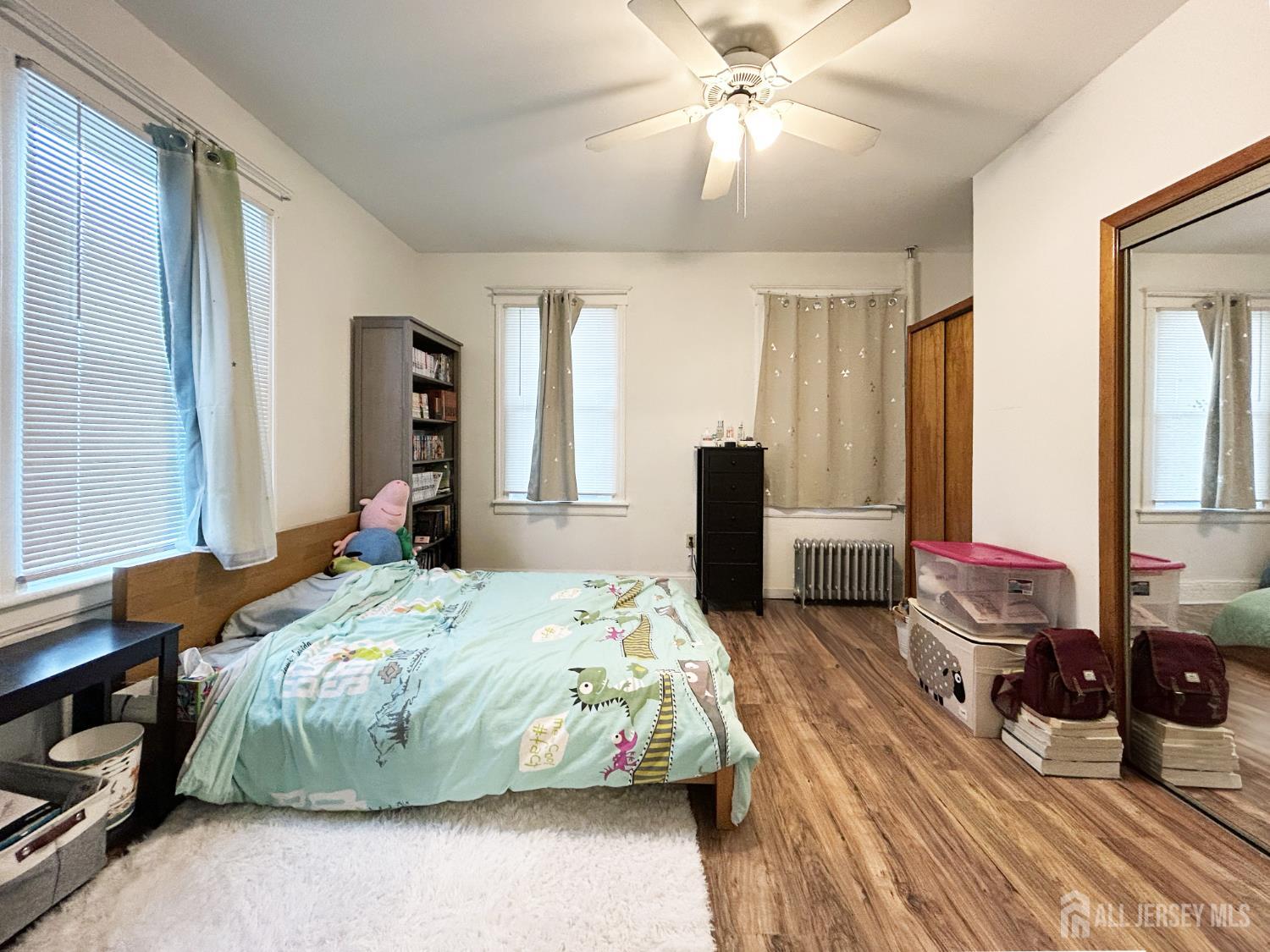 104 Thompson Street Raritan, NJ 08869 - Photo 7 of 10 a bedroom with bed and large windows