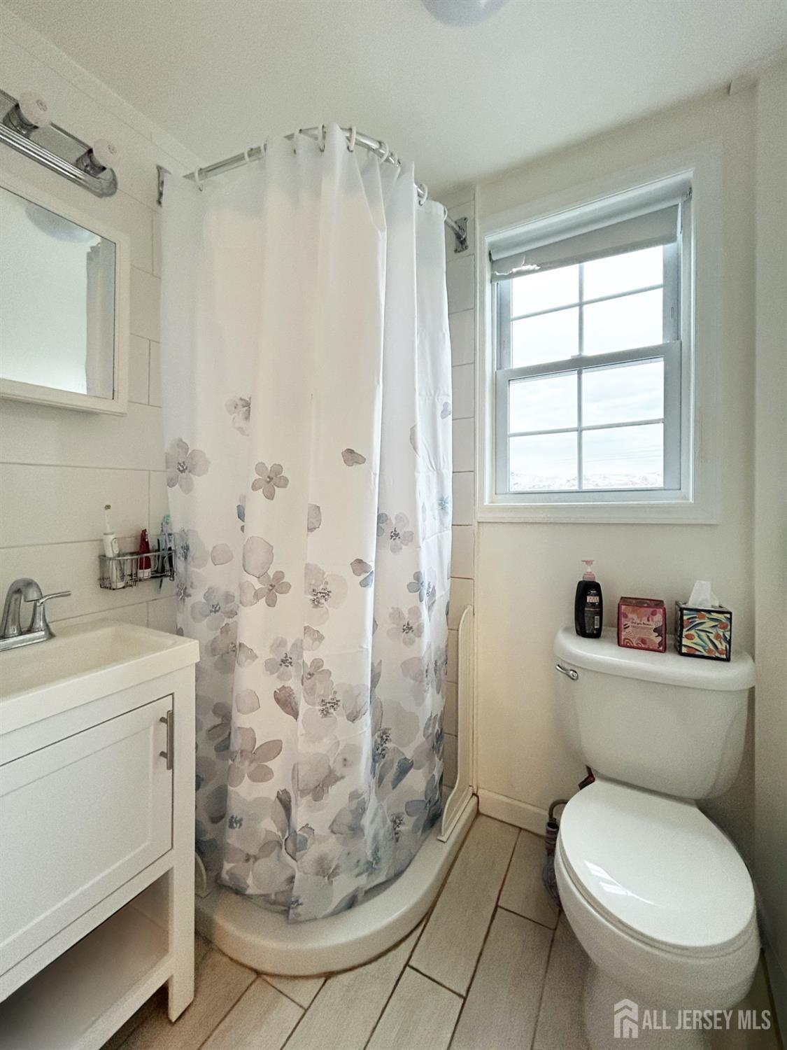 104 Thompson Street Raritan, NJ 08869 - Photo 9 of 10 a white toilet sitting next to a bathroom sink