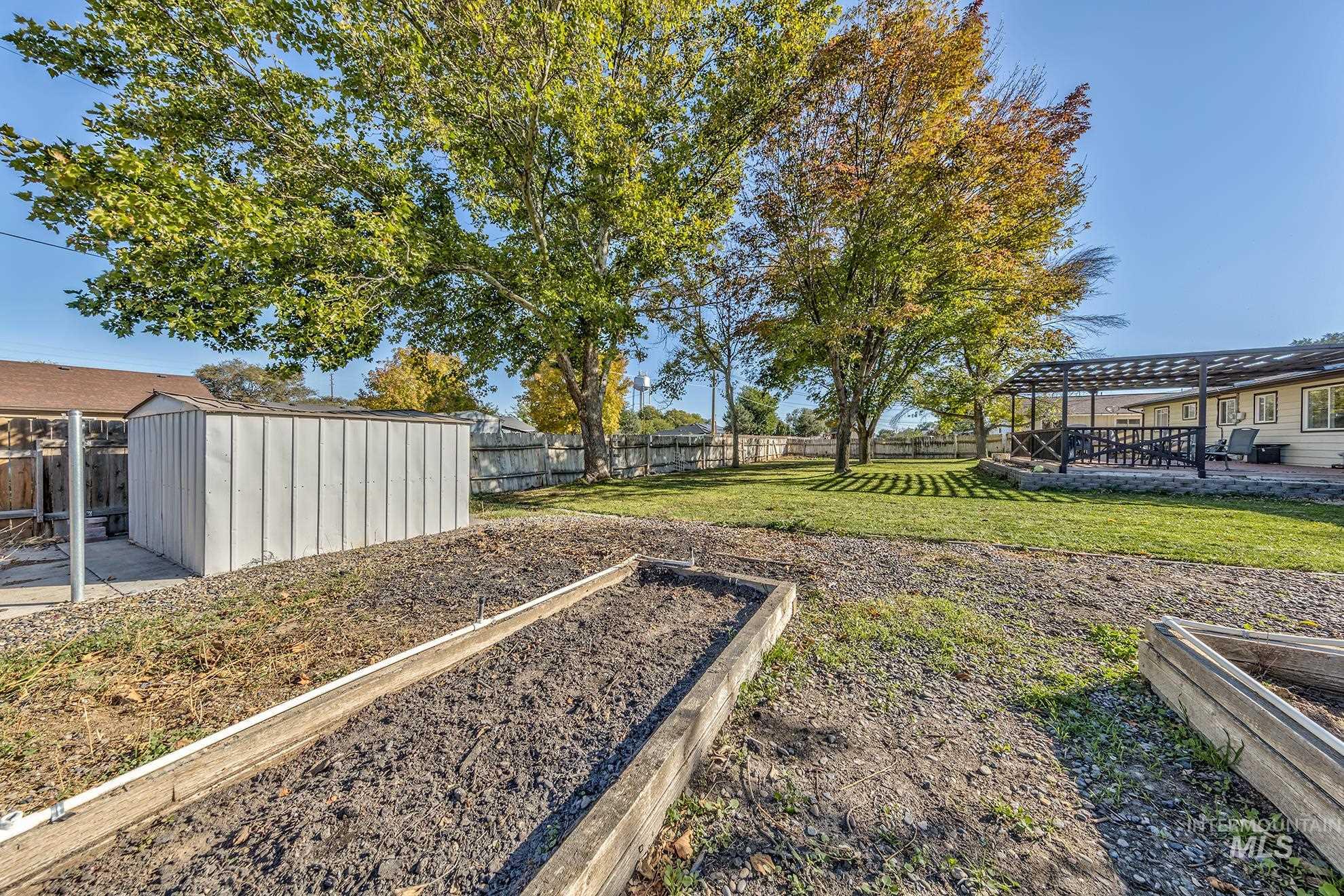 710 North 5th Street Nyssa, OR 97913 - Photo 30 of 36 Fenced backyard featuring a garden, a shed, and a patio area