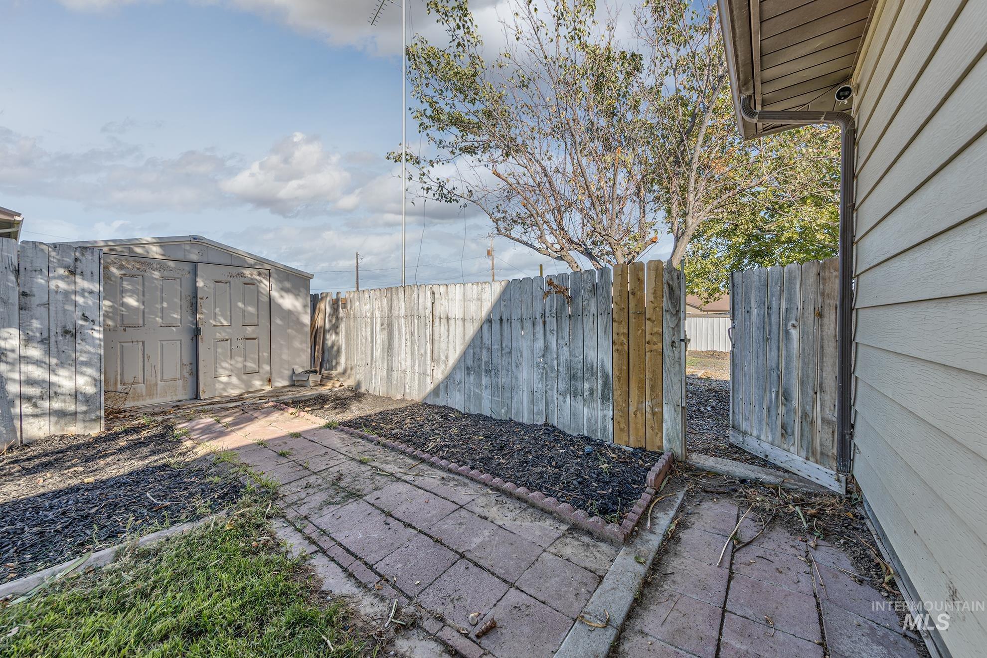 710 North 5th Street Nyssa, OR 97913 - Photo 36 of 36 Fenced backyard featuring a storage shed and a patio area