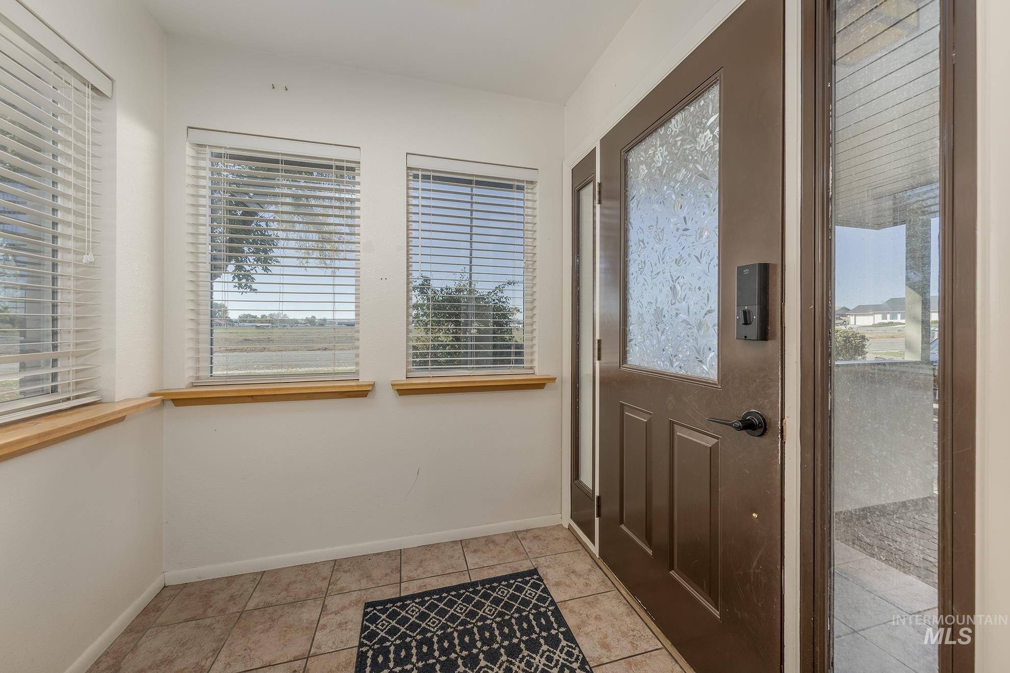 710 North 5th Street Nyssa, OR 97913 - Photo 6 of 36 Doorway to outside with tile patterned floors and baseboards