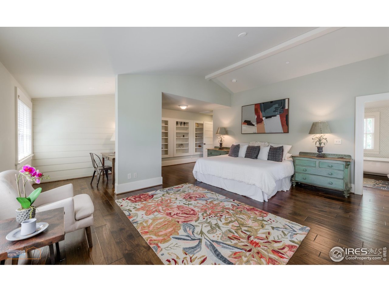 8522 Valmont Road Boulder, CO 80301 - Photo 19 of 49 a bedroom with a bed and wooden floor