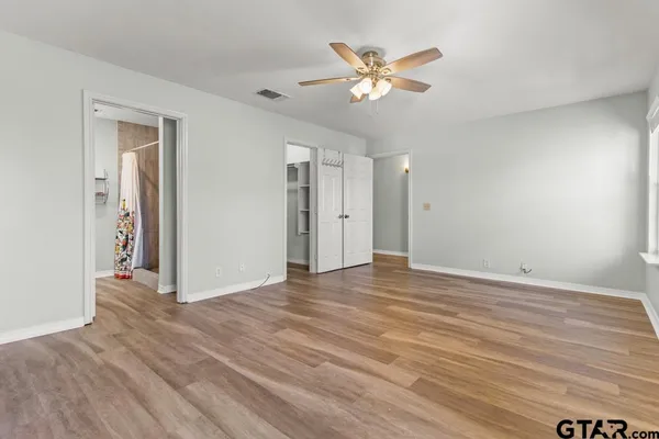 a view of an empty room with wooden floor