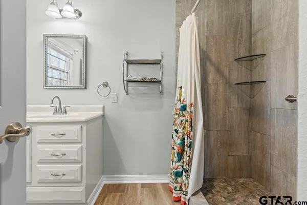 a bathroom with a shower and a sink