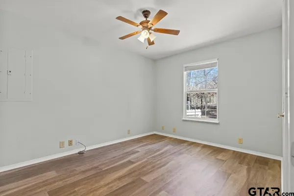 a view of empty room with wooden floor