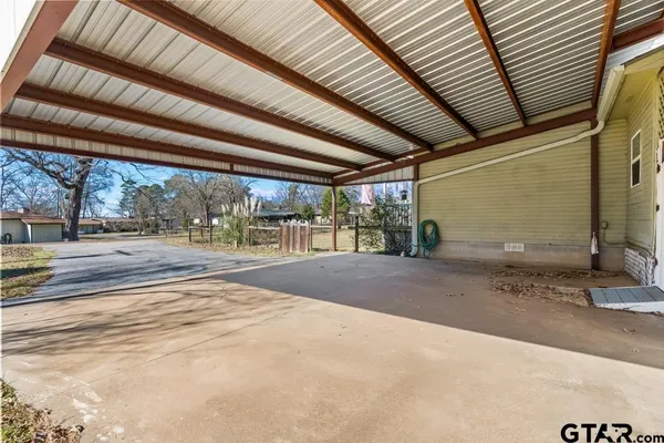 a view of a patio with a table and chairs