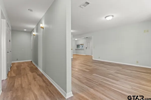 a view of hallway with wooden floor