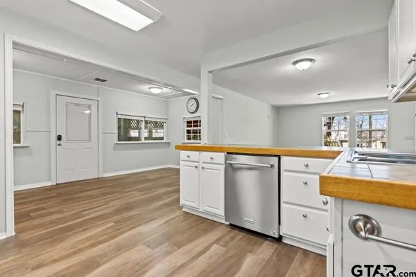 a kitchen with a wooden floor and white appliances