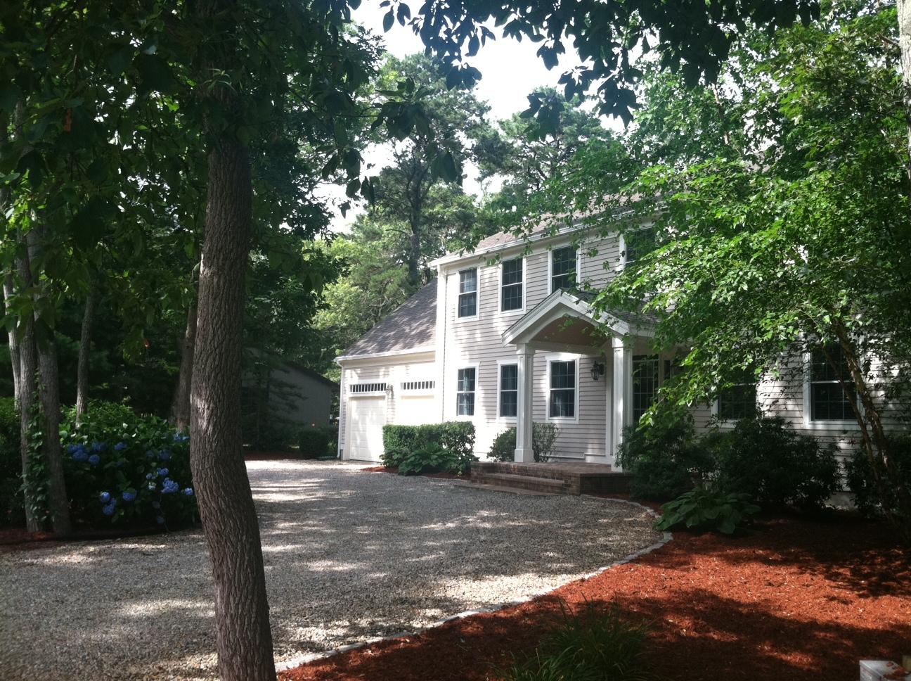108 Fells Pond Road Mashpee, MA 02649 - Photo 1 of 35 a front view of a house with a garden