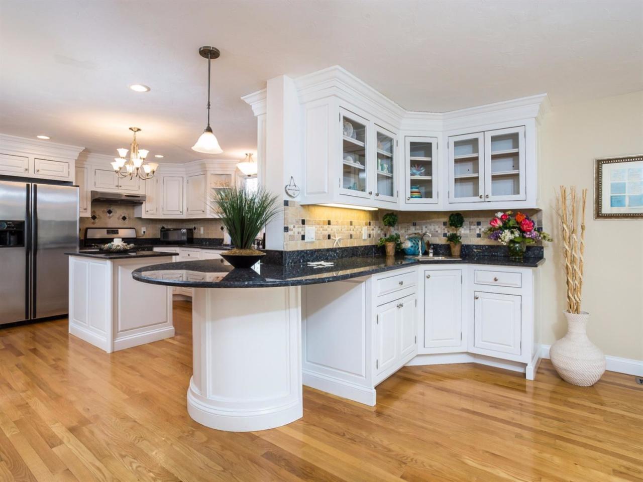 108 Fells Pond Road Mashpee, MA 02649 - Photo 11 of 35 a kitchen with stainless steel appliances granite countertop a stove a sink and a refrigerator