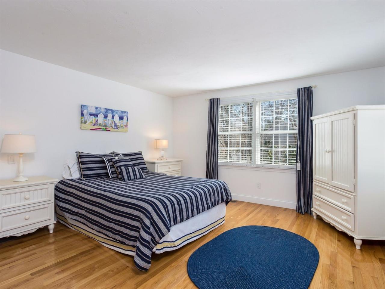 108 Fells Pond Road Mashpee, MA 02649 - Photo 15 of 35 a bedroom with a bed and wooden floor