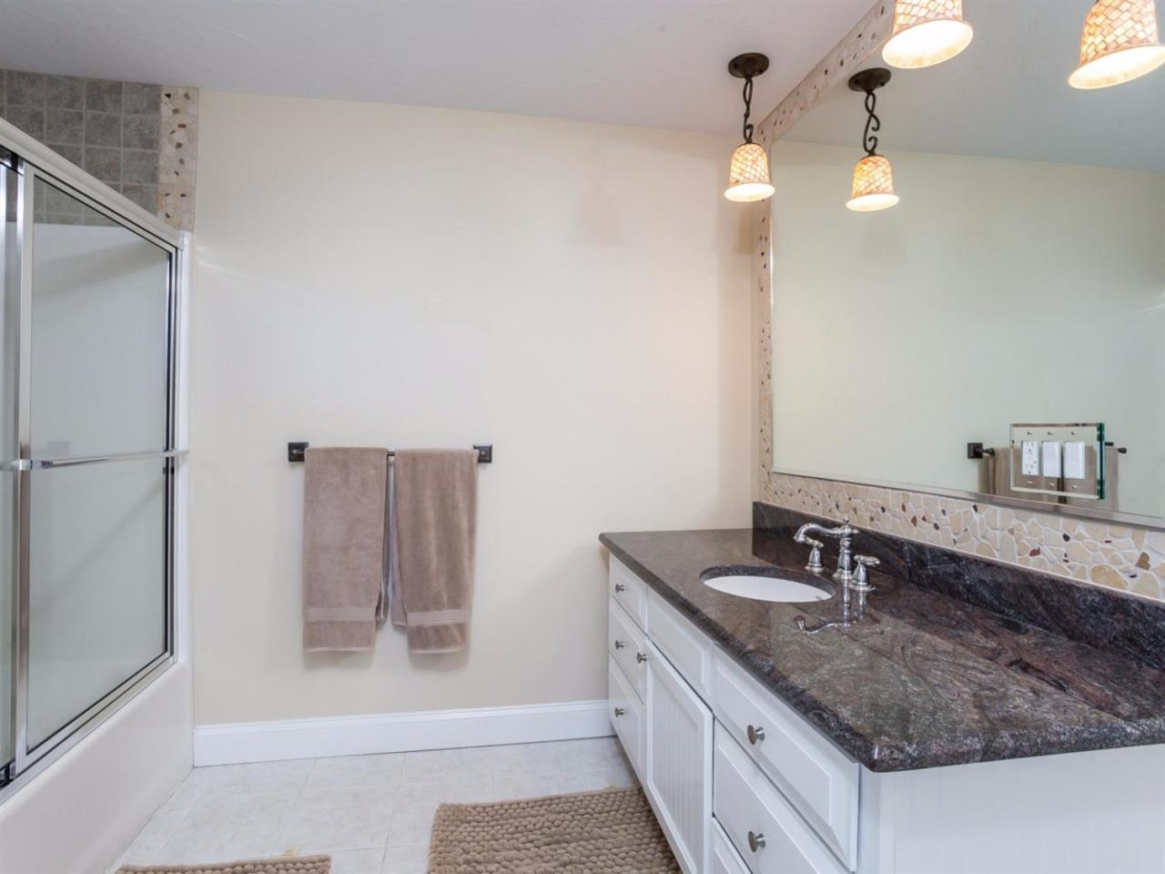 108 Fells Pond Road Mashpee, MA 02649 - Photo 21 of 35 a bathroom with a granite countertop sink a toilet a mirror and shower