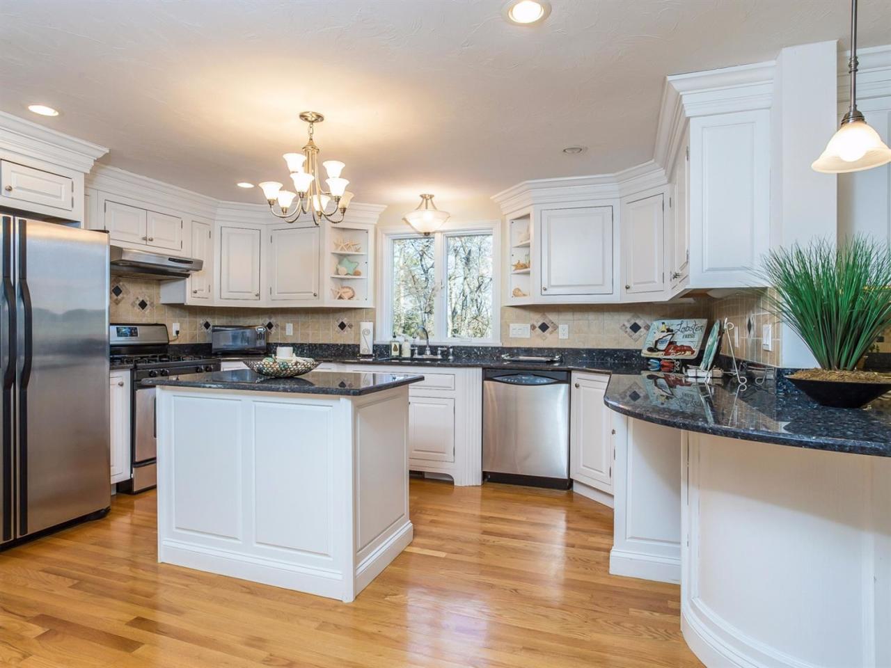 108 Fells Pond Road Mashpee, MA 02649 - Photo 9 of 35 a kitchen with kitchen island granite countertop a sink cabinets and stainless steel appliances