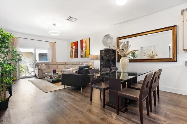 a living room with furniture and paintings on the wall