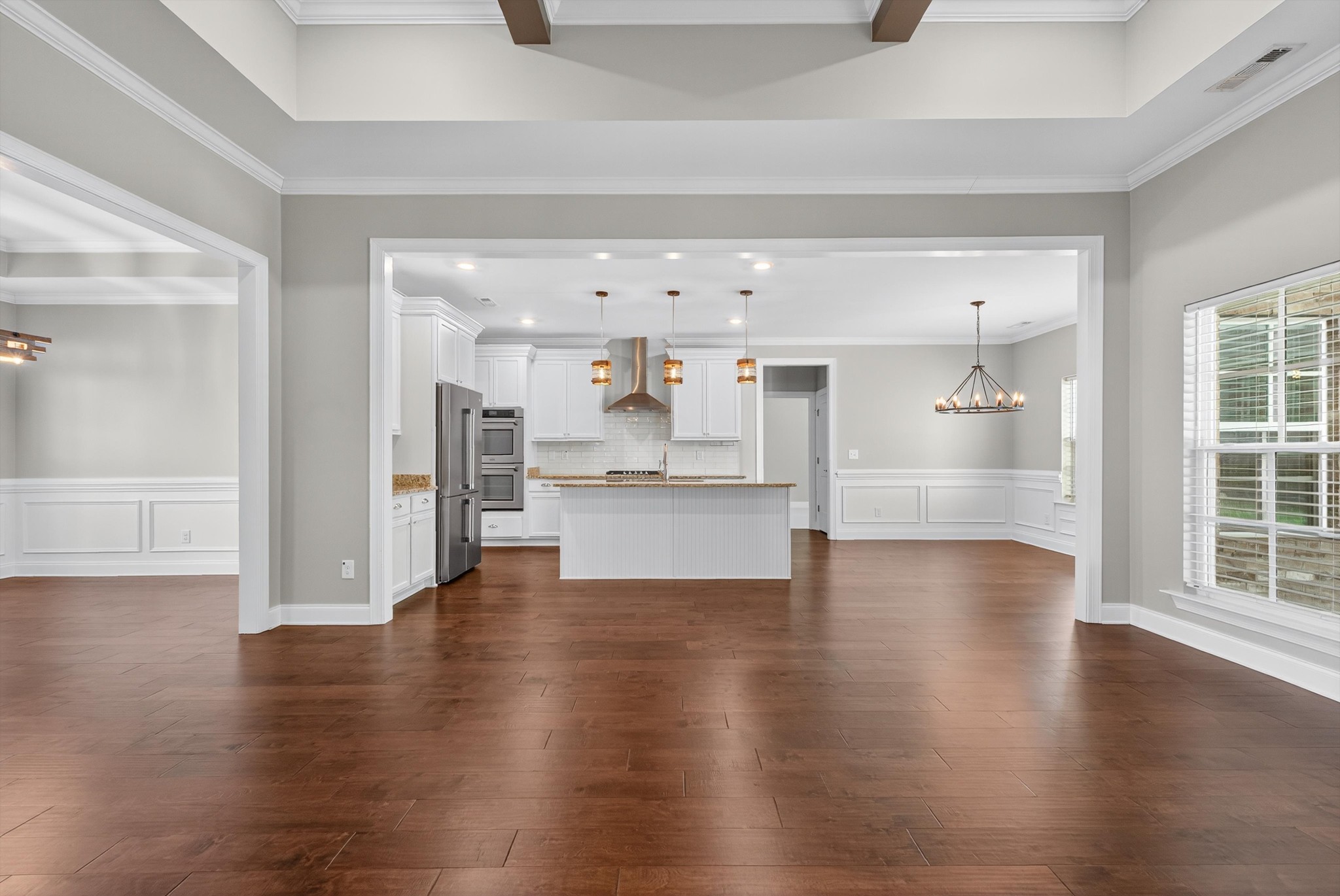 7401 Swindon Boulevard Fairview, TN 37062 - Photo 15 of 57 a view of an empty room with wooden floor and a kitchen