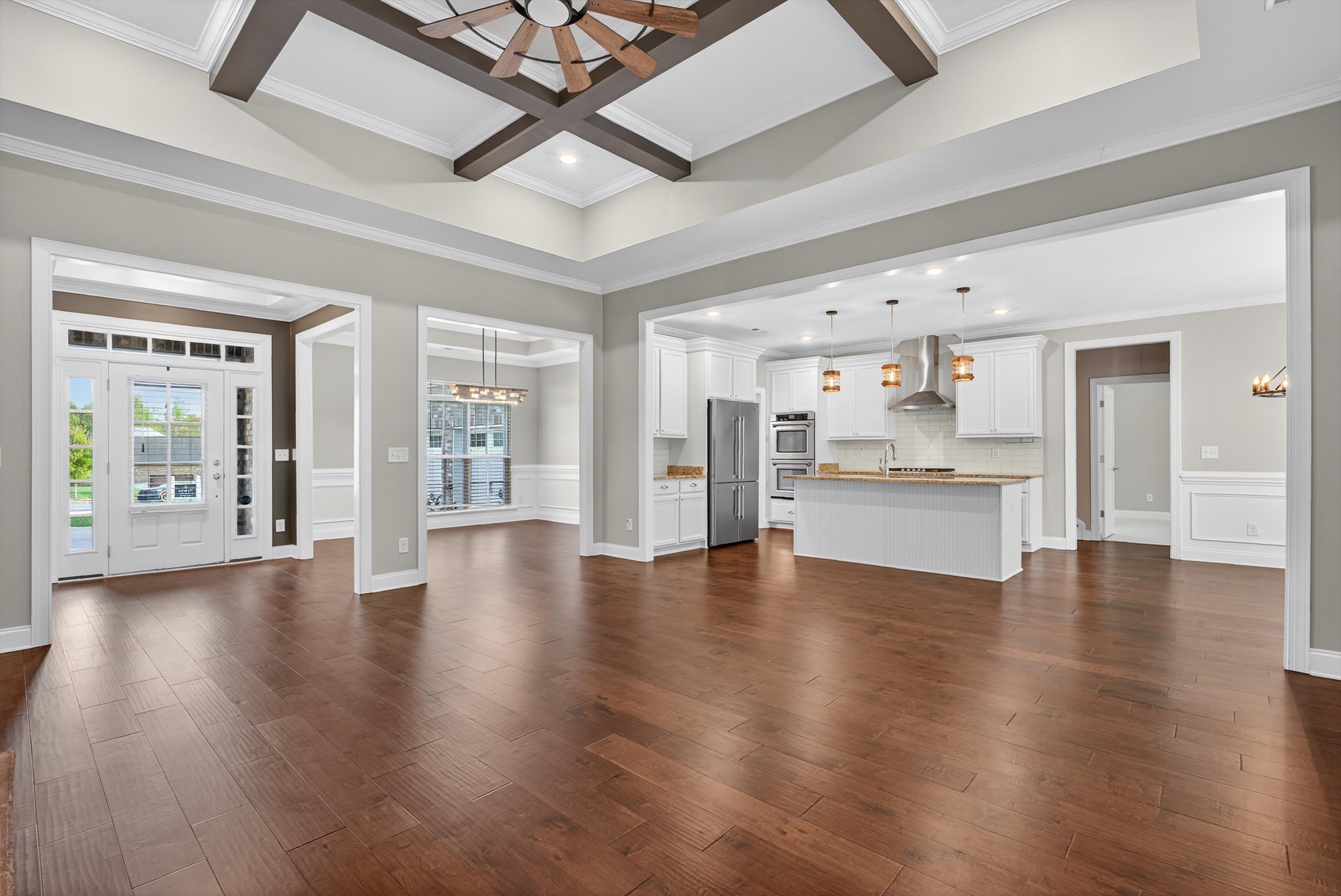7401 Swindon Boulevard Fairview, TN 37062 - Photo 17 of 57 a view of an empty room with wooden floor and a kitchen