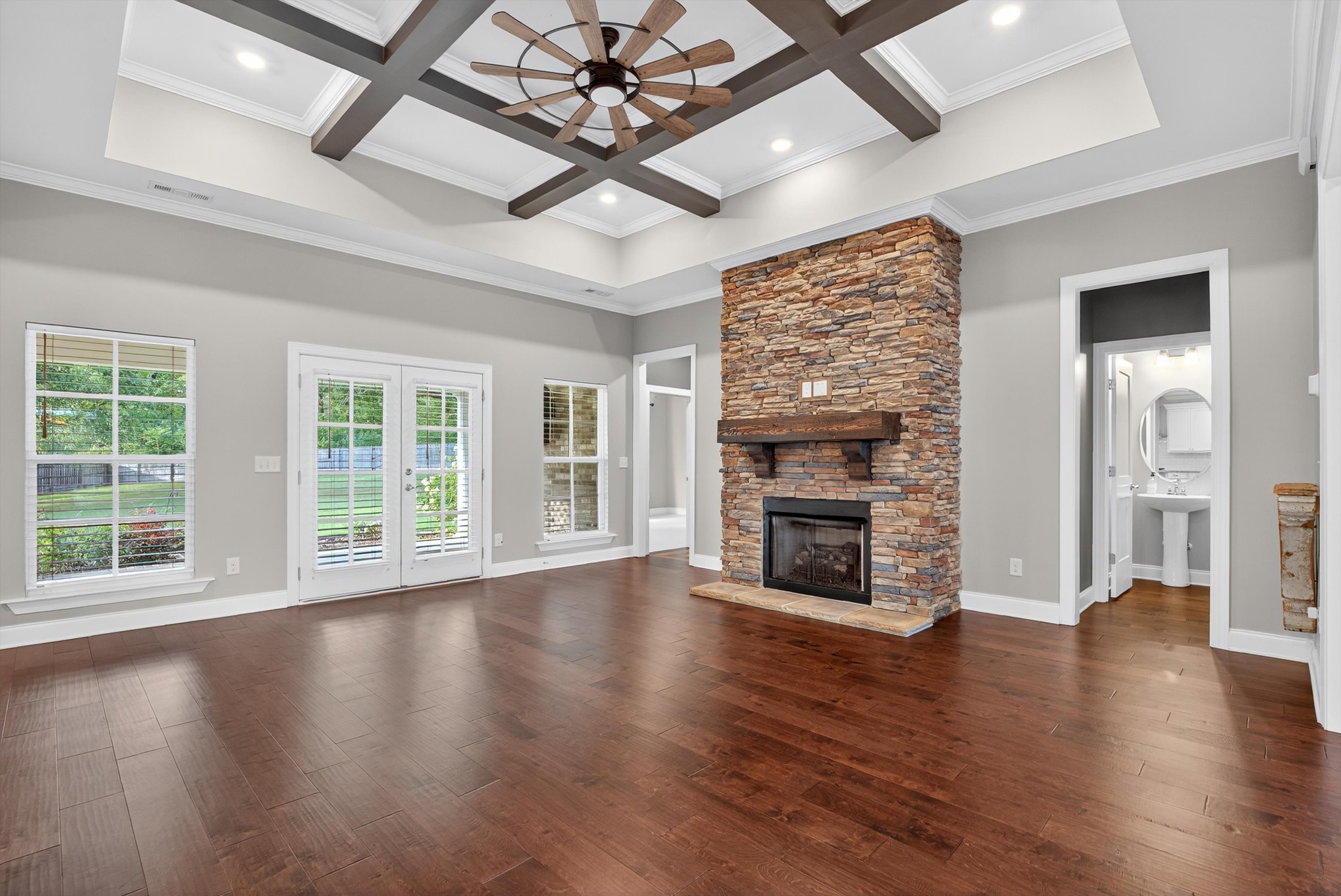 7401 Swindon Boulevard Fairview, TN 37062 - Photo 19 of 57 an empty room with wooden floor fireplace and windows