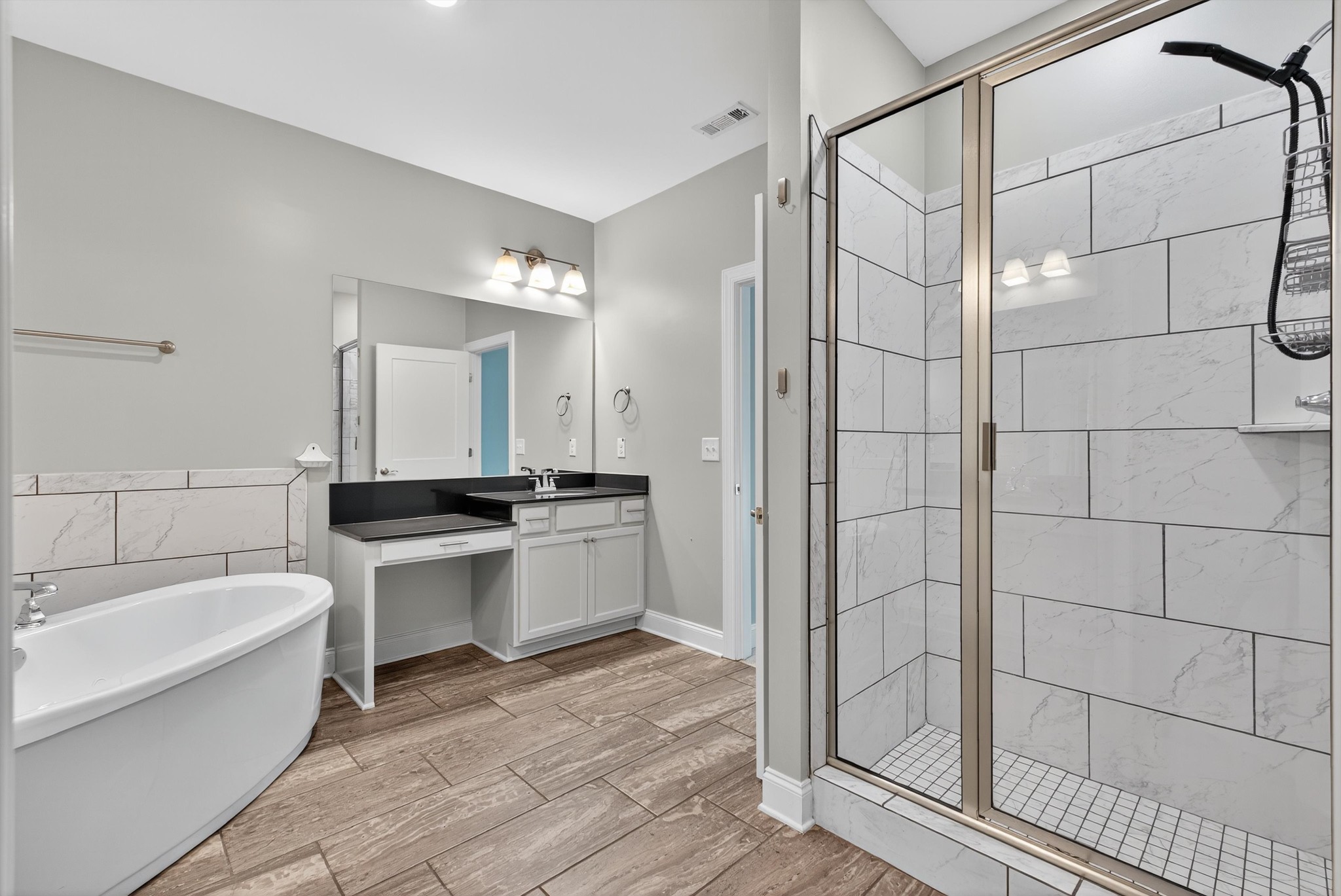 7401 Swindon Boulevard Fairview, TN 37062 - Photo 32 of 57 a bathroom with a tub a sink and a mirror