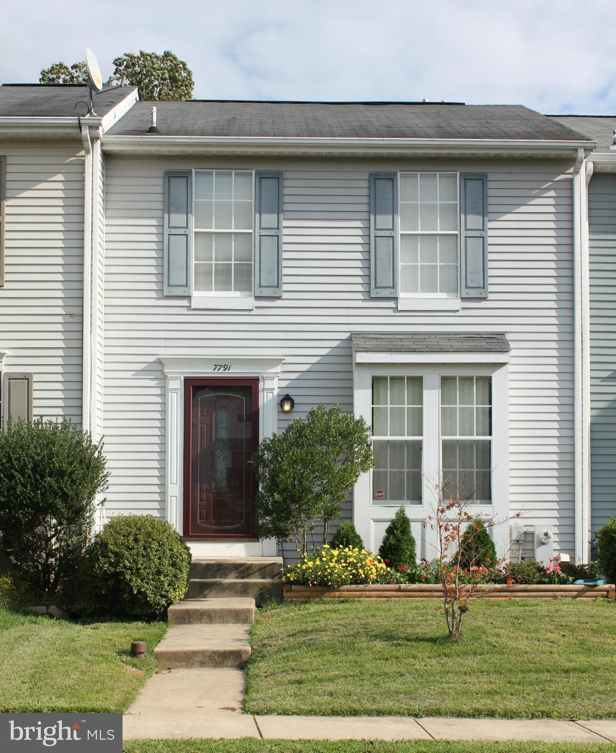 7791 Paddock Way Baltimore, MD 21244 - Photo 1 of 19 a front view of a house with garden