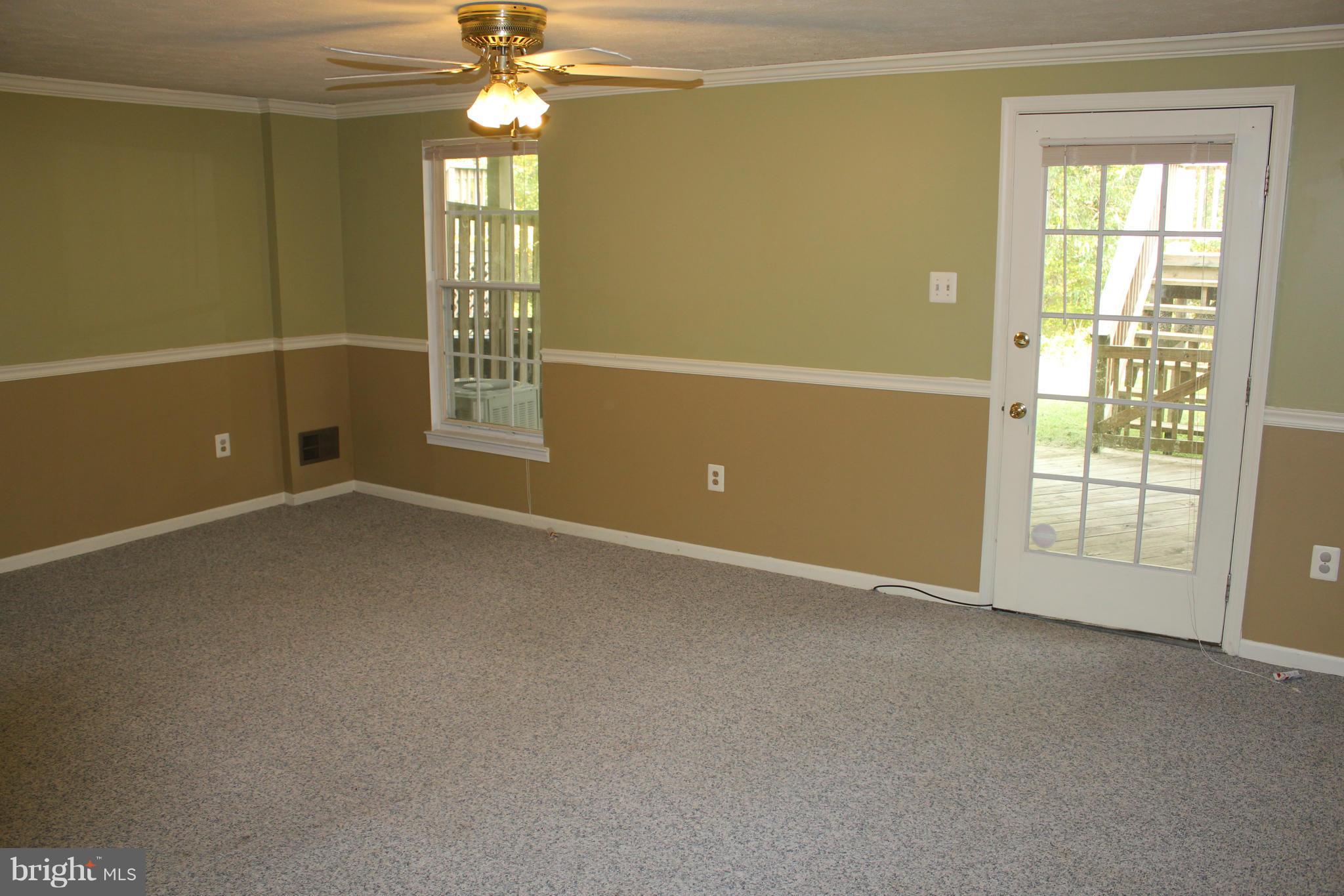 7791 Paddock Way Baltimore, MD 21244 - Photo 14 of 19 an empty room with windows and chandelier fan