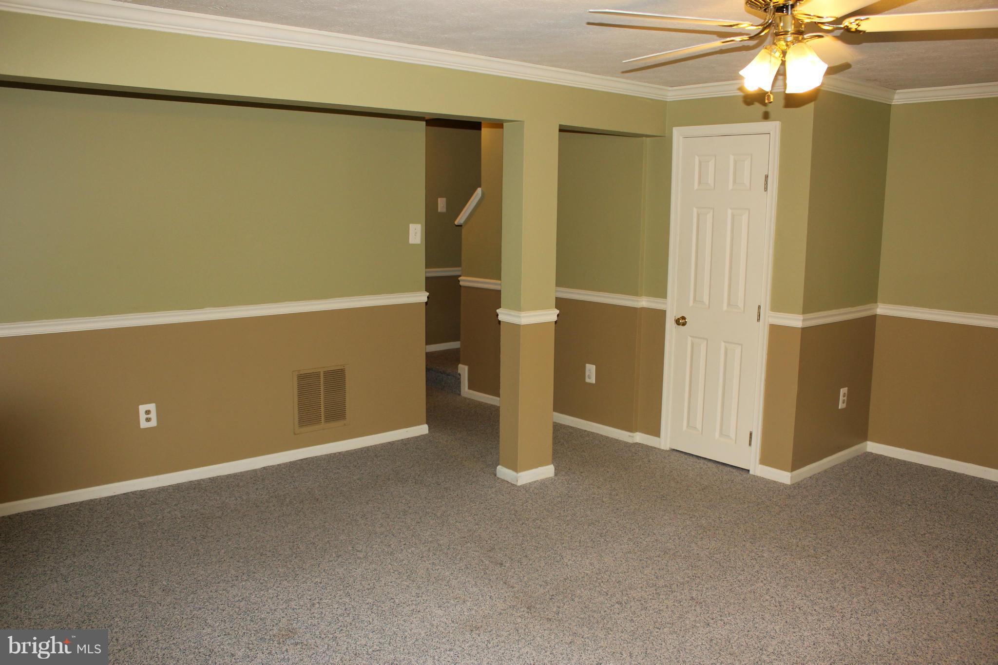 7791 Paddock Way Baltimore, MD 21244 - Photo 15 of 19 a view of an empty room with a chandelier fan