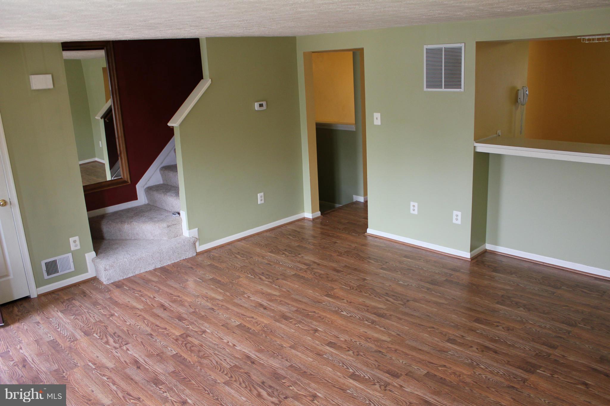 7791 Paddock Way Baltimore, MD 21244 - Photo 3 of 19 an empty room with wooden floor and windows