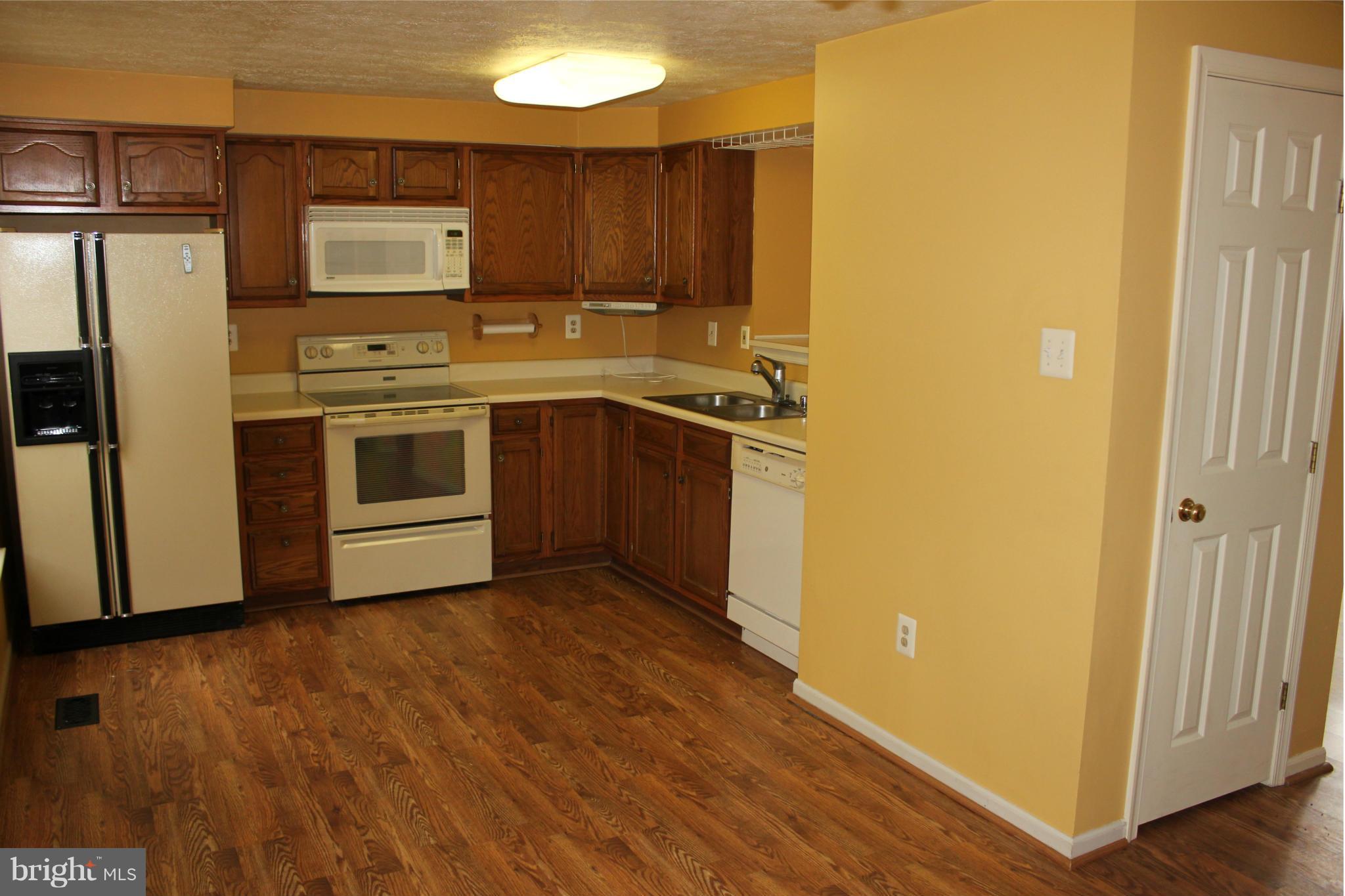 7791 Paddock Way Baltimore, MD 21244 - Photo 6 of 19 a kitchen with stainless steel appliances a refrigerator and a stove