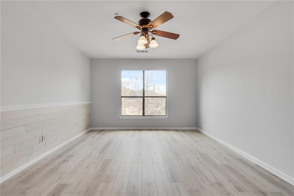 821 Ralph McGill Boulevard Northeast, Unit 3247 Atlanta, GA 30306 - Photo 13 of 43 wooden floor in an empty room with a window