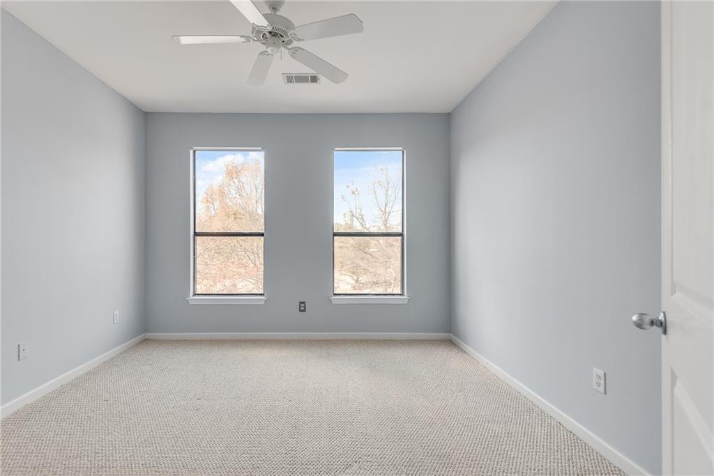 821 Ralph McGill Boulevard Northeast, Unit 3247 Atlanta, GA 30306 - Photo 22 of 43 an empty room with a window and a fan
