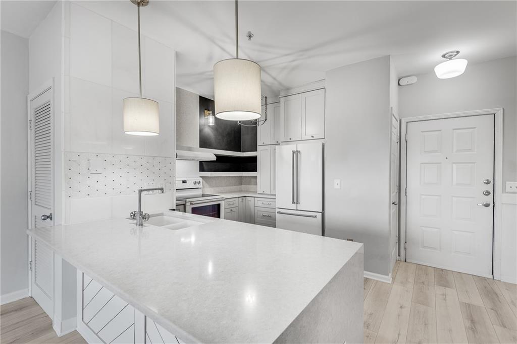 821 Ralph McGill Boulevard Northeast, Unit 3247 Atlanta, GA 30306 - Photo 3 of 43 a kitchen with stainless steel appliances a microwave a sink a stove and refrigerator