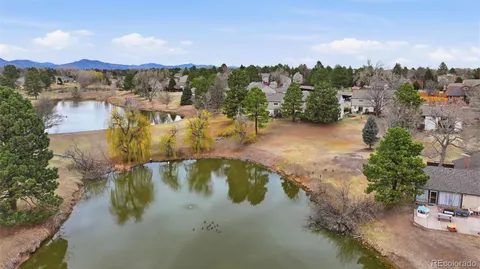a backyard of a house with lots of green space and lake view