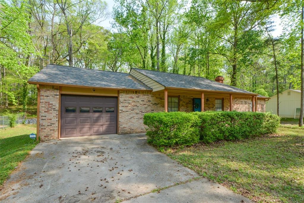 5224 McCarter Station Stone Mountain, GA 30088 - Photo 1 of 1 a front view of a house with a garden