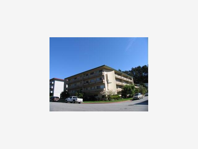 a picture of a bench in front of a building