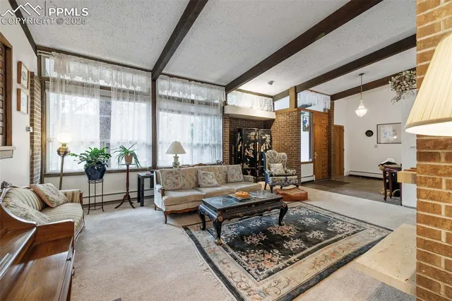 a living room with furniture and view of kitchen