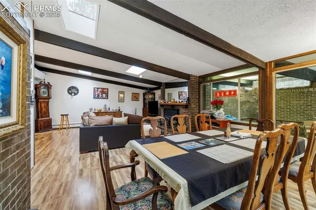 a kitchen with kitchen island a stove a table and chairs in it