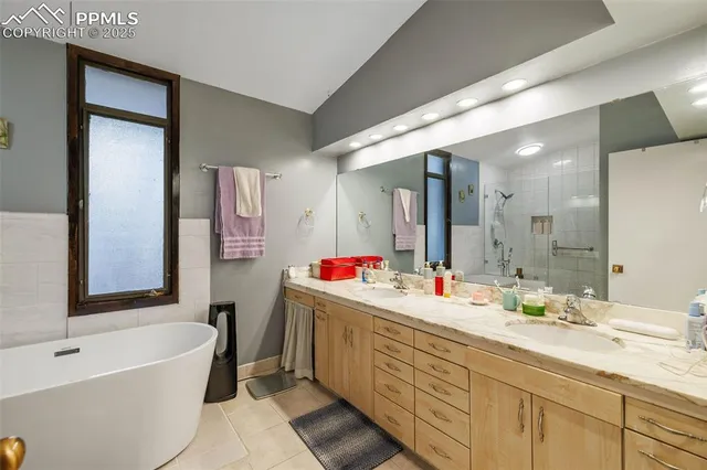 a bathroom with a tub shower and a toilet