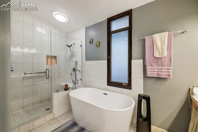 a walk in closet with wooden floor