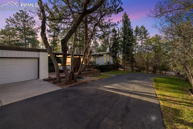 a view of a street with some trees on the side of the road
