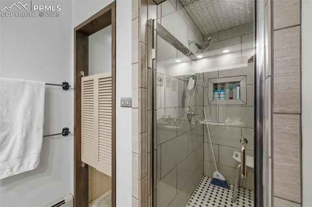 a view of a dining room with furniture one side kitchen view and wooden floor