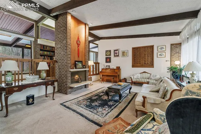 a living room with furniture a rug and a window