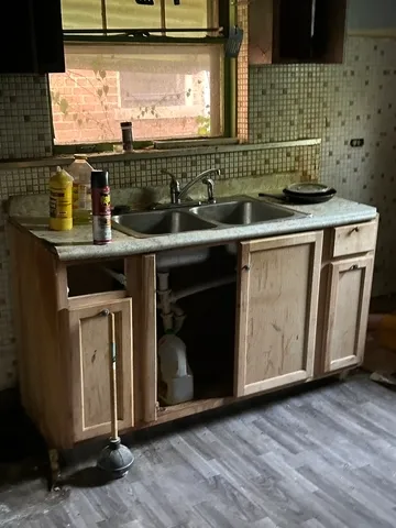 a kitchen with granite countertop a sink and a stove