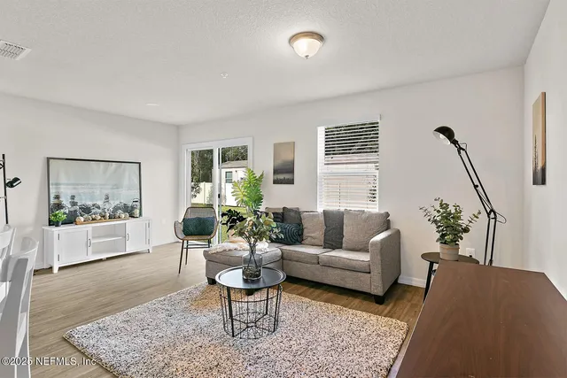 a living room with furniture and a potted plant