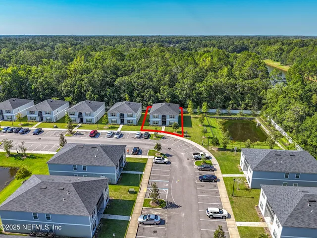 an aerial view of residential houses with outdoor space and swimming pool